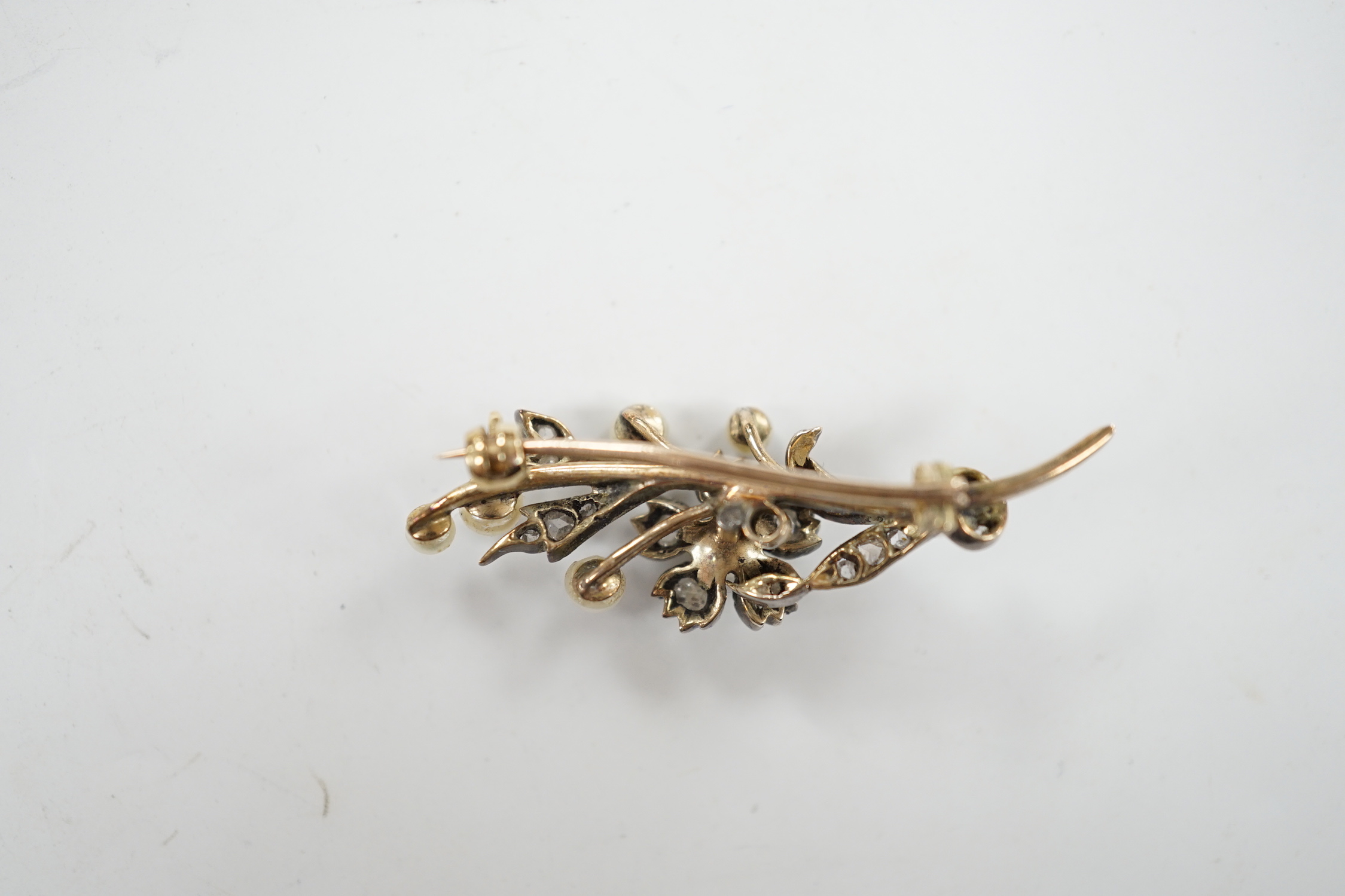 A cased Victorian yellow metal, seed pearl and rose cut diamond set foliate spray brooch, 39mm, gross weight 4.4 grams.